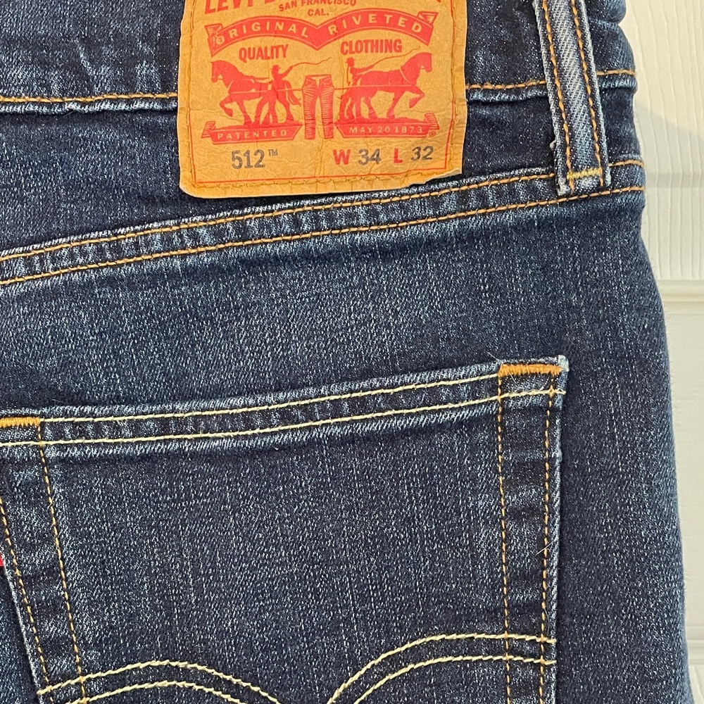 Levi's Size 34x32 dark blue denim jeans with tan leather patch